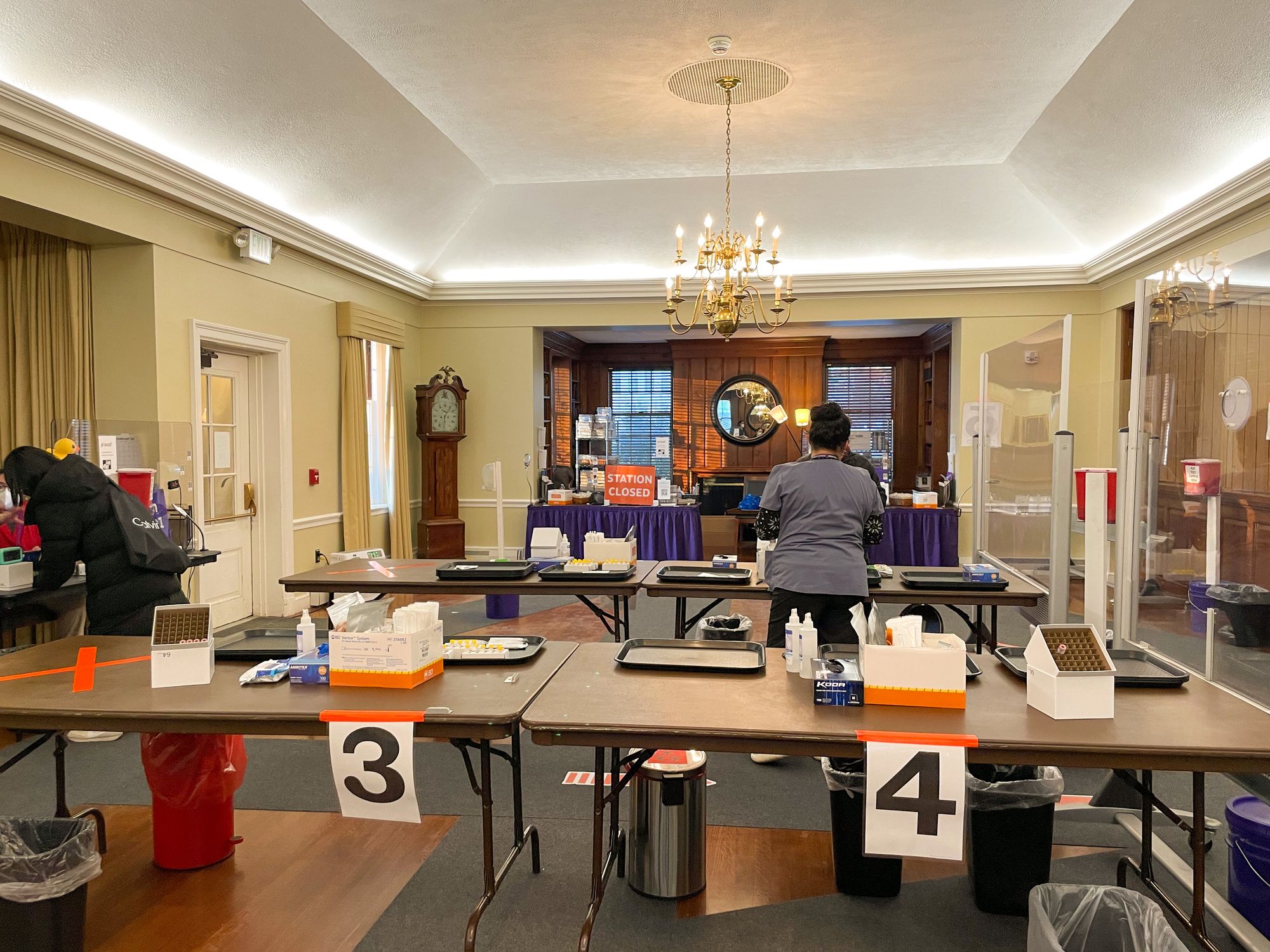 Image of tables set up in testing center with covid tests on top.