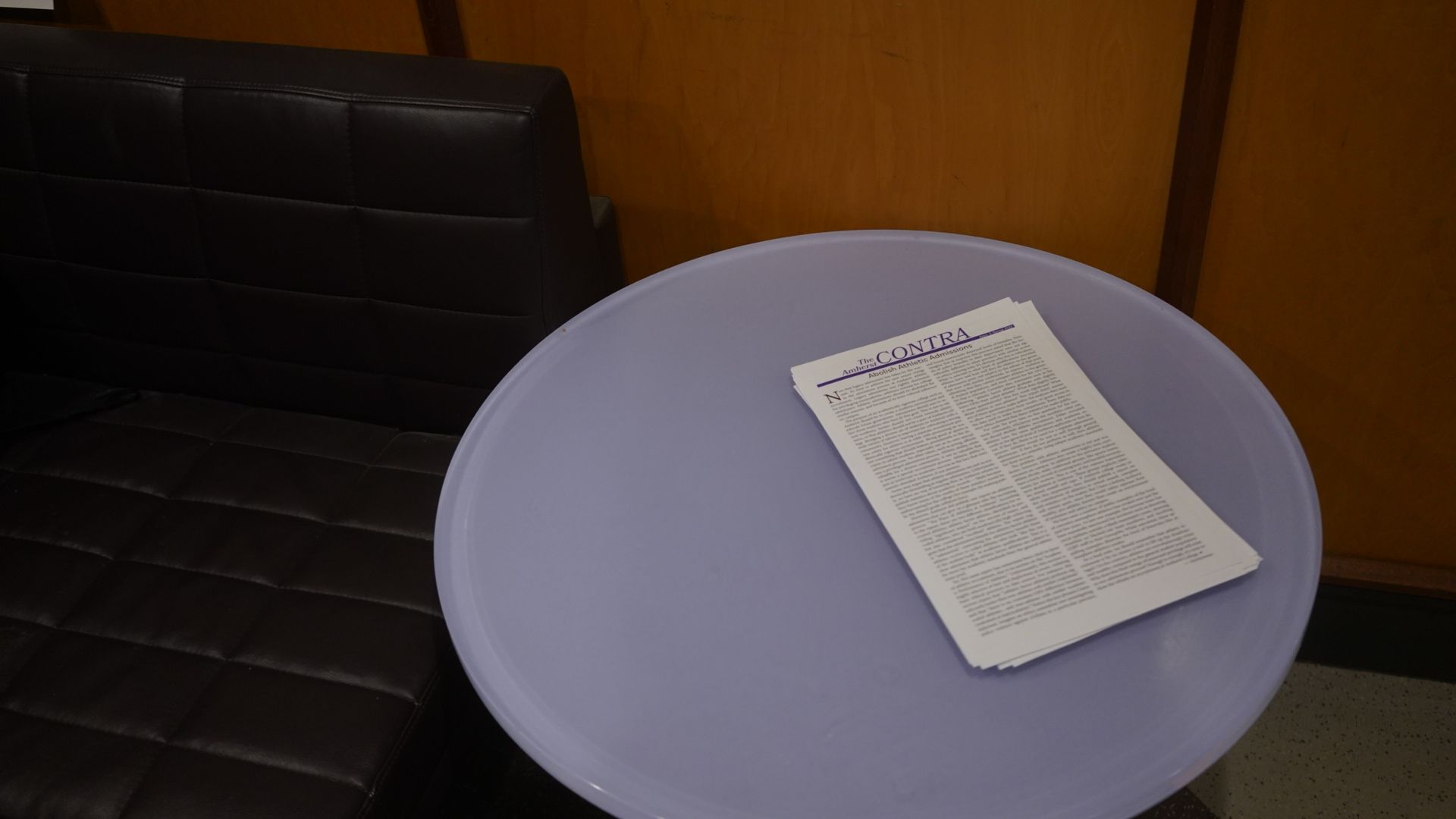 The image depicts several copies of The Contra sitting on a table in Valentine Dining Hall